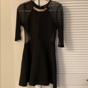 Black Sheer Peplum Dress with Chain Detail
